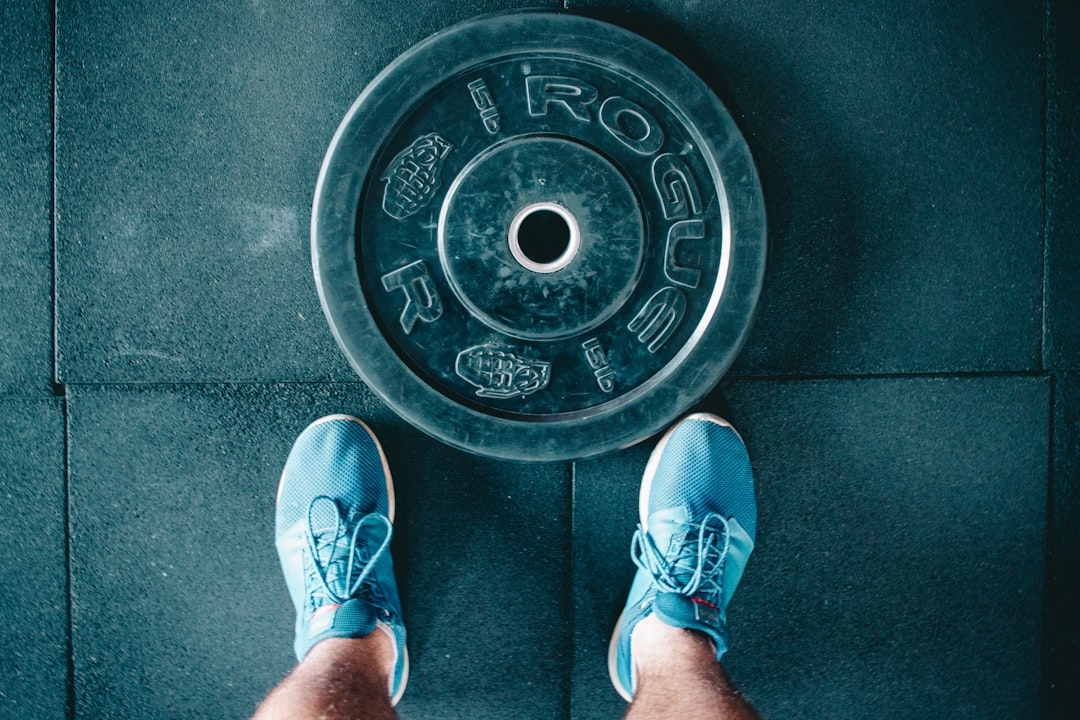 person-standing-beside-black-weights-pnm-9vbeqhk