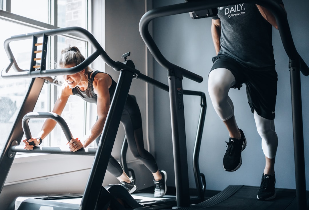 woman-in-black-tank-top-and-black-shorts-sitting-on-black-exercise-equipment-y7ywdxwj-ju